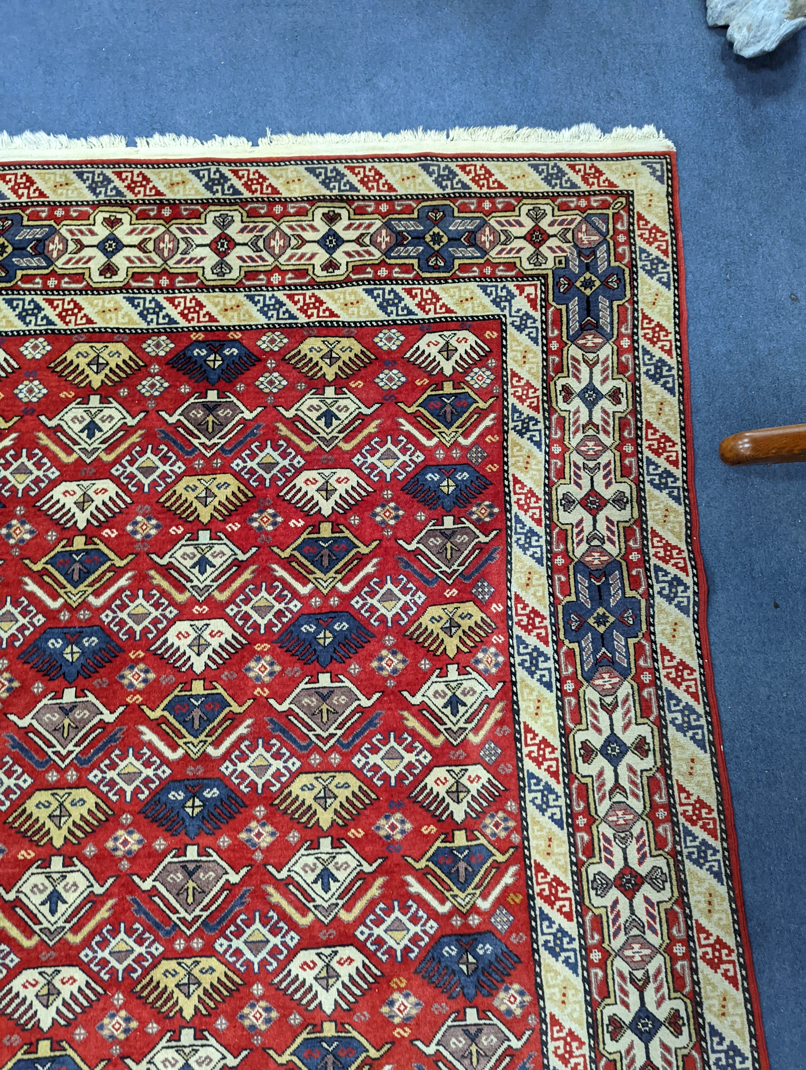 A Caucasian style red ground rug, 210 x 140cm